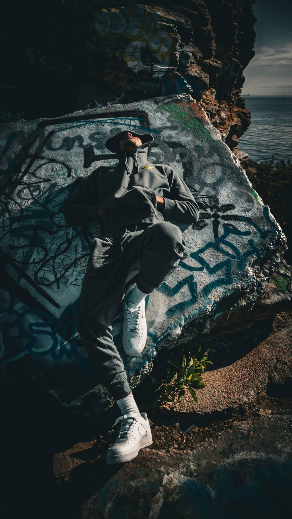 BailMoney lifestyle campaign portrait photographed on coastal rocks