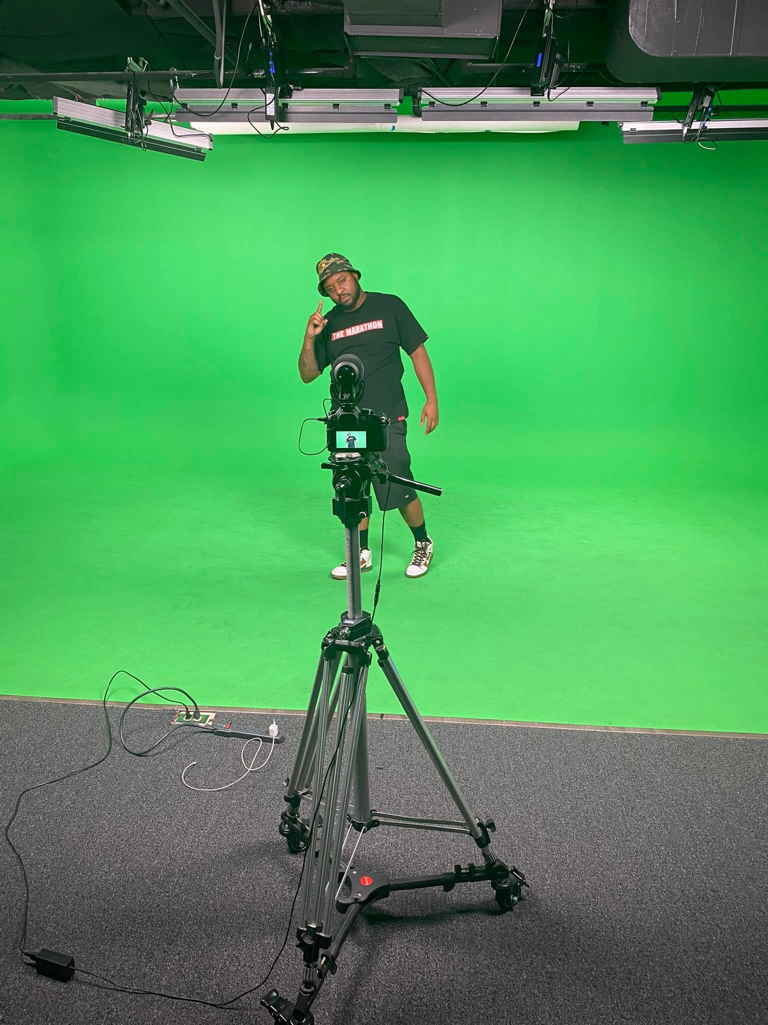 Digital Cheese Productions camera setup and crew member on a full green-screen stage