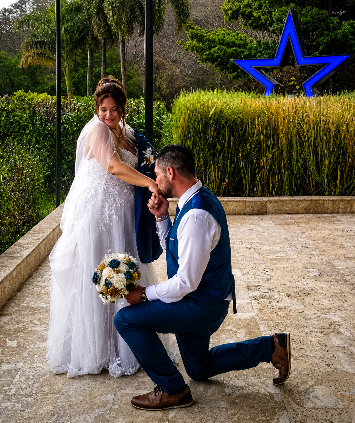 Groom kissing the bride's hand at the resort